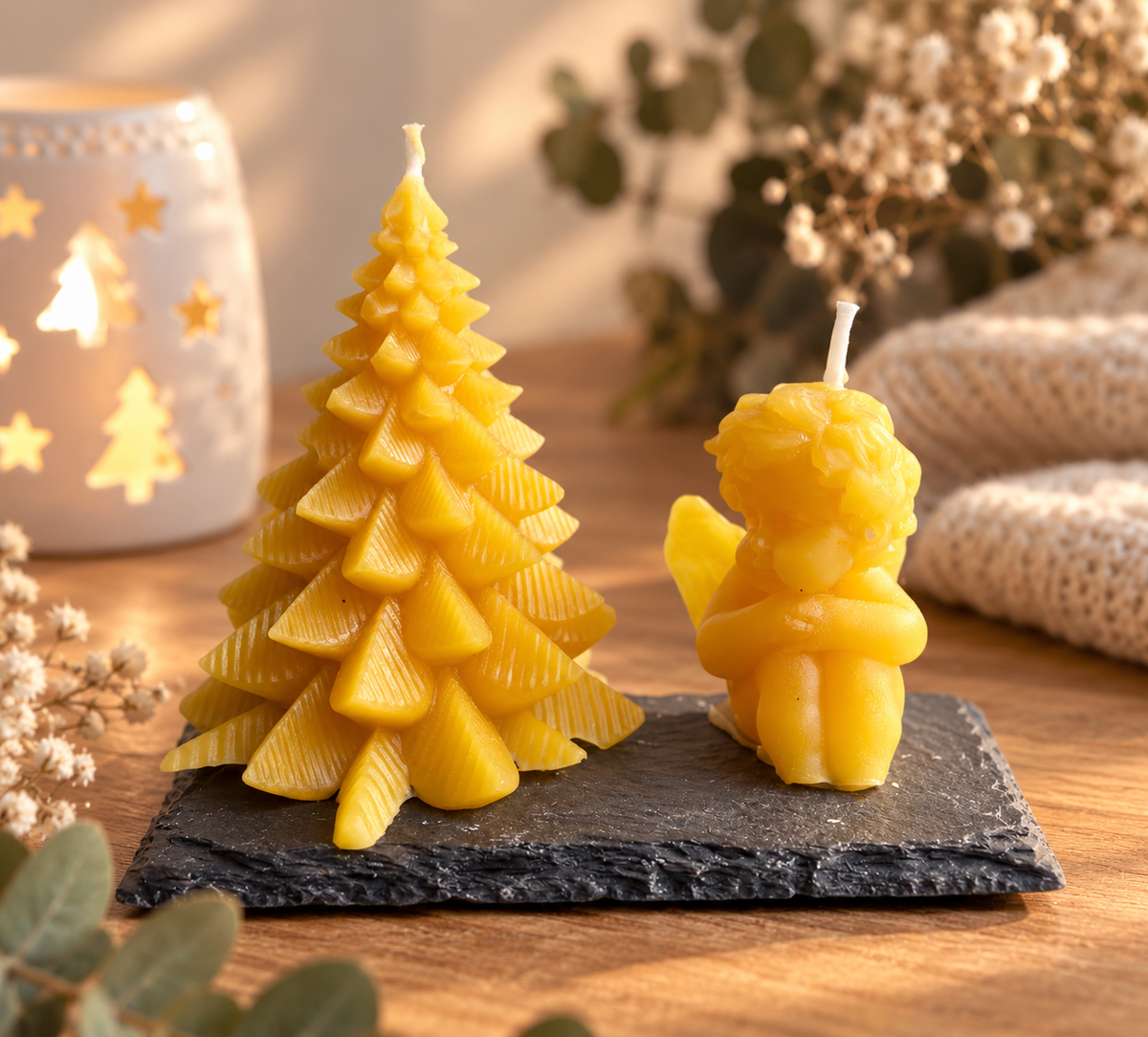 Handgegossene Bienenwachskerzen als Engel und Tannenbaum in weihnachtlicher Dekoration