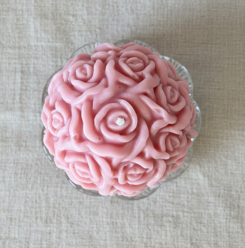 Draufsicht auf handgemachte rosa Rosenkerze aus Kerzenresten, nachhaltige Upcycling Deko