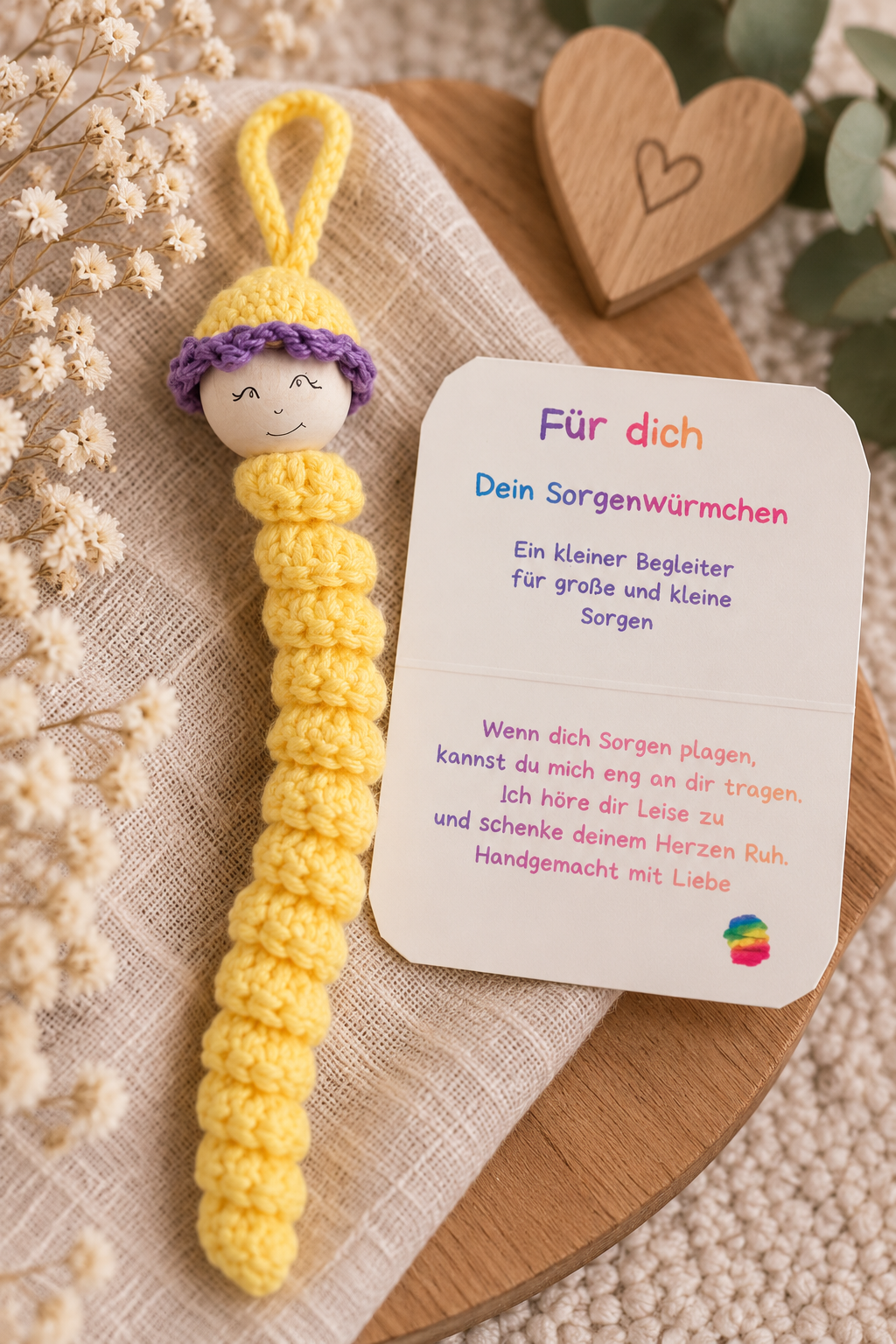 Handgemachtes gelbes Sorgenwürmchen mit lila Mütze und liebevollem Kärtchen „Für dich“