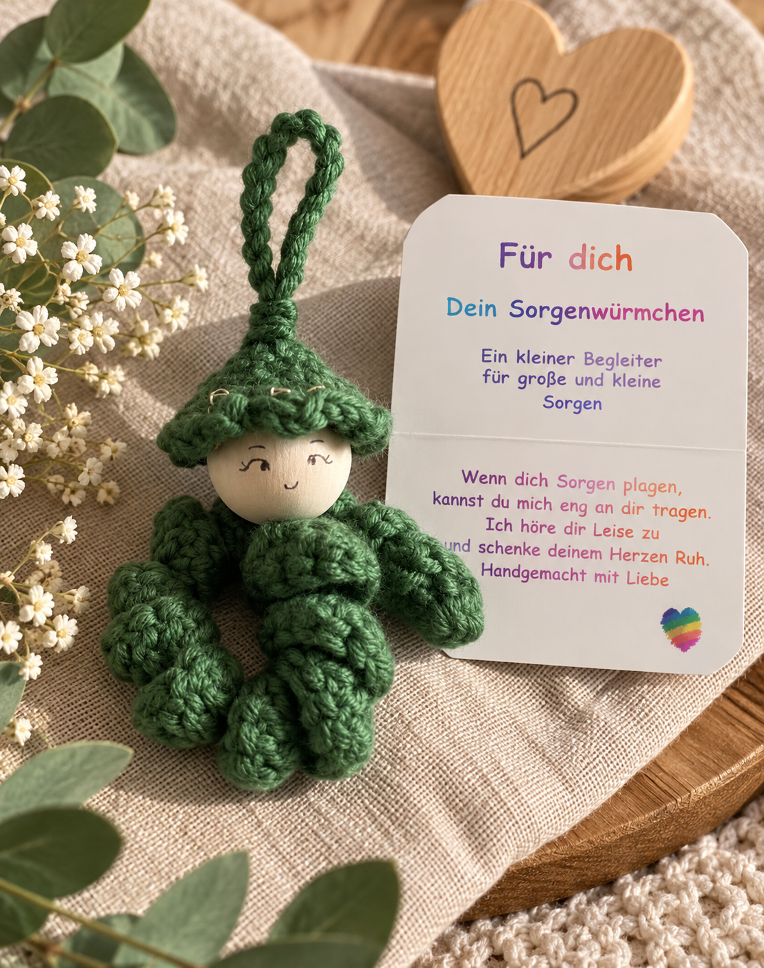 Handgemachtes grünes Sorgenwürmchen mit Kärtchen „Für dich“, liebevoll als kleiner Glücksbringer arrangiert.